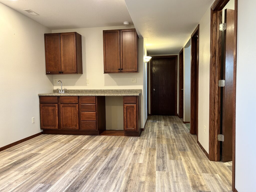 Professional basement finishing project featuring a custom cabinetry and recessed lighting in Tea, SD.