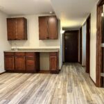 Professional basement finishing project featuring a custom cabinetry and recessed lighting in Tea, SD.