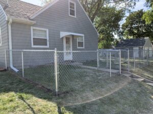 Professional chain link fence installation featuring galvanized steel mesh and secure top-rail construction in Tea, SD.