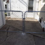 Commercial-grade chain link gate installation with galvanized steel framing and secure latch hardware in Sioux Falls, SD.