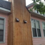 Professional chimney box repair and cedar siding replacement featuring weather-resistant materials in Sioux Falls, SD.