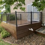 Custom low-maintenance composite deck installation with picture-frame bordering and matching skirt in Harrisburg, SD.