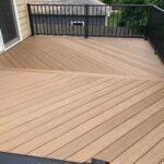 Custom composite deck construction and professional outdoor living space installation for a residential home in Renner, SD.