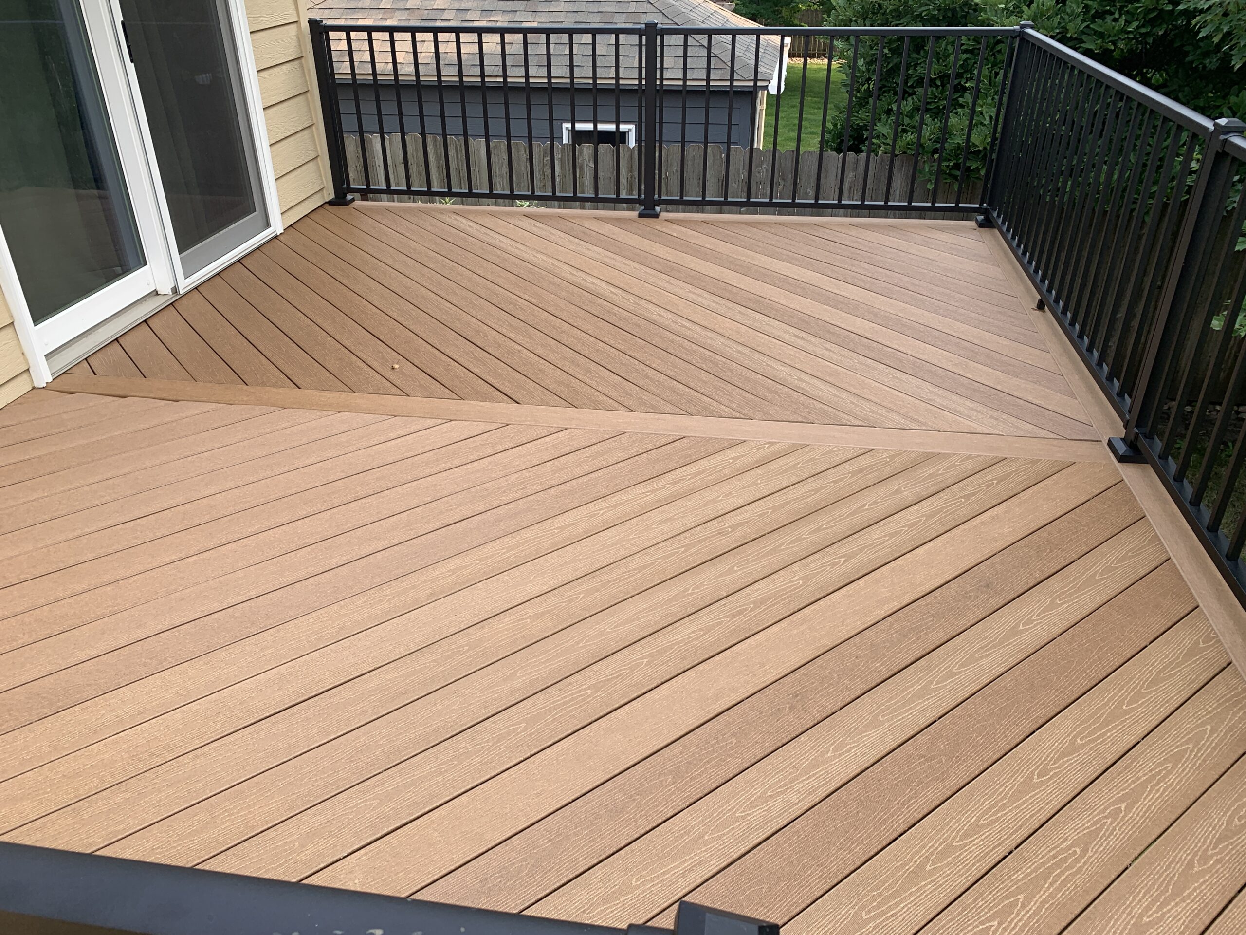 Custom composite deck construction and professional outdoor living space installation for a residential home in Renner, SD.