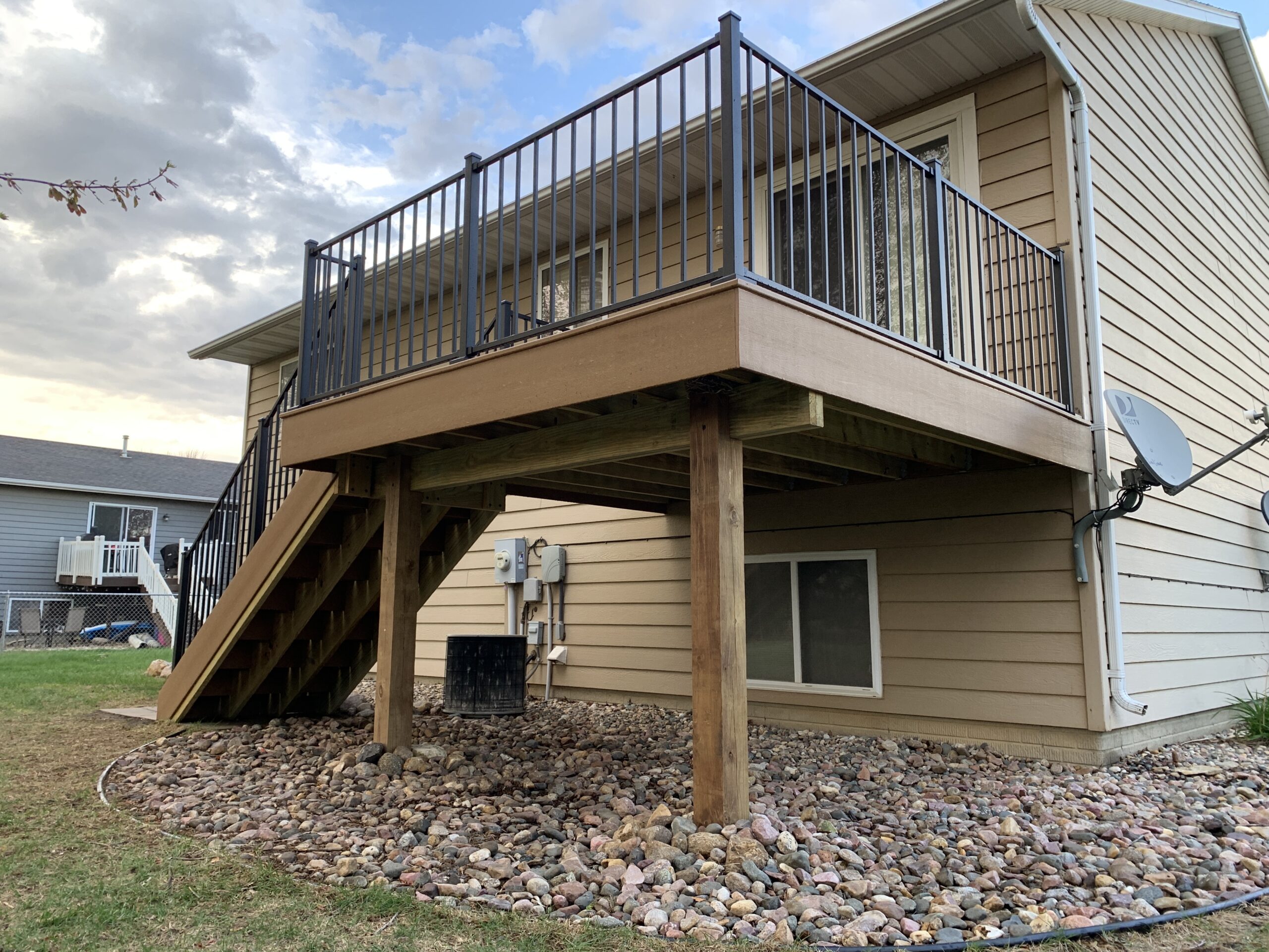 Professional composite deck installation featuring low-maintenance PVC decking and custom railing in Tea, SD.