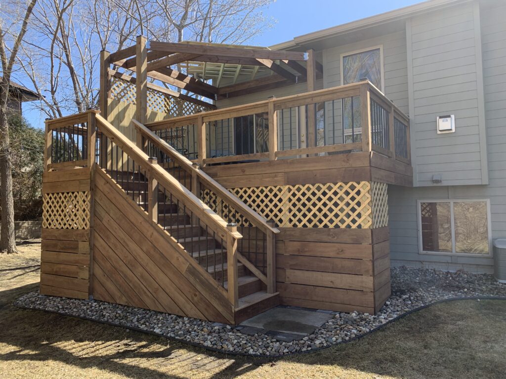 Custom Craftsman style wood deck installation with heavy timber framing and professional staining in Lennox, SD.