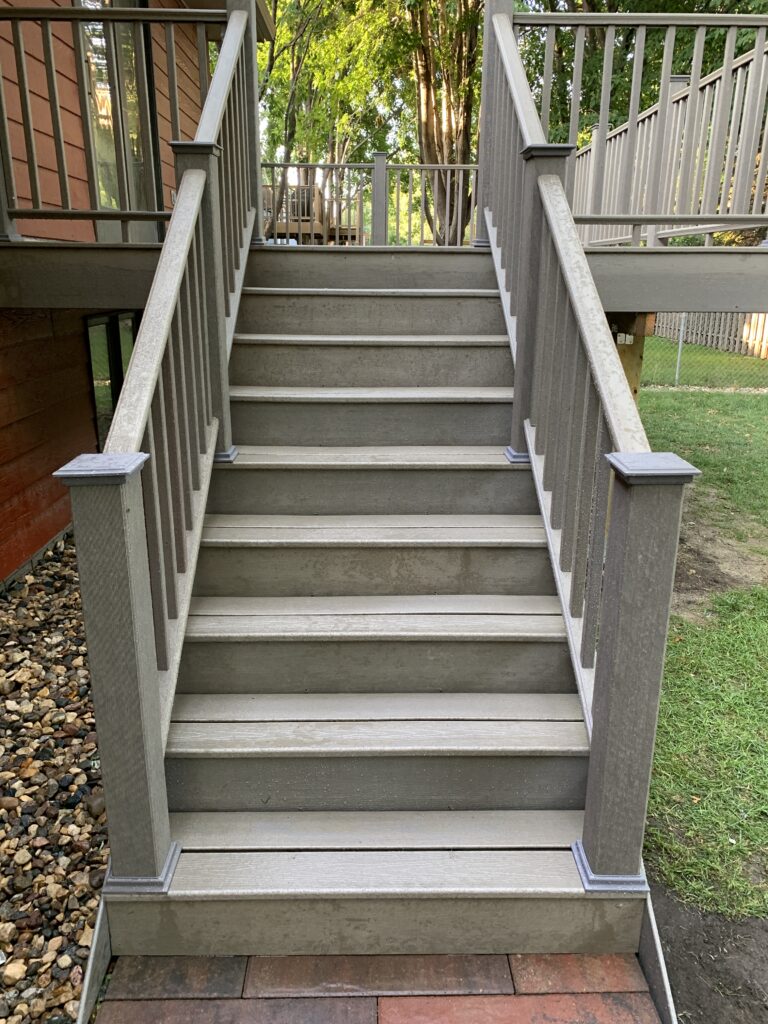 Professional deck stair replacement in a gray Timber Tech composite for a residential backyard in Canton, SD.