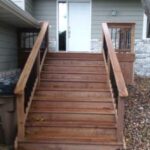 Professional deck stair replacement and structural stringer repair for a residential backyard in Sioux Falls, SD.