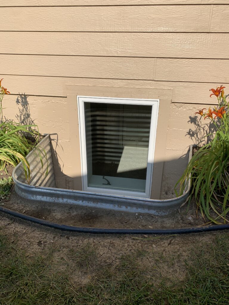 Code-compliant egress window installation and basement excavation services for a residential home in Lennox, SD.