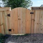 Professional residential gate repair and hardware restoration for a privacy fence in Sioux Falls, SD.