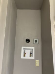 Modern main floor laundry room remodel with custom cabinetry and folding station for a residential home in Sioux Falls, SD.