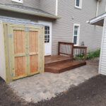 Professional concrete paver patio installation and custom outdoor living space for a new construction home in Harrisburg, SD.