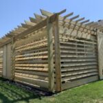 Custom wood pergola installation and decorative outdoor timber structure for a new construction home in Harrisburg, SD.