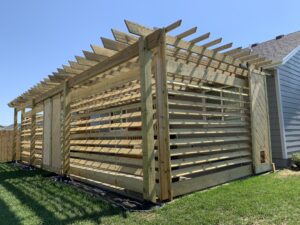 Custom wood pergola installation and decorative outdoor timber structure for a new construction home in Harrisburg, SD.
