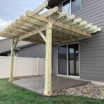 Custom wood pergola installation and decorative outdoor timber structure for a residential patio in Hartford, SD.
