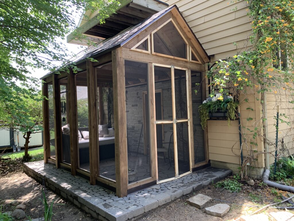 Custom 3-season porch addition with a vaulted wood ceiling and screened in windows in Brandon, SD.