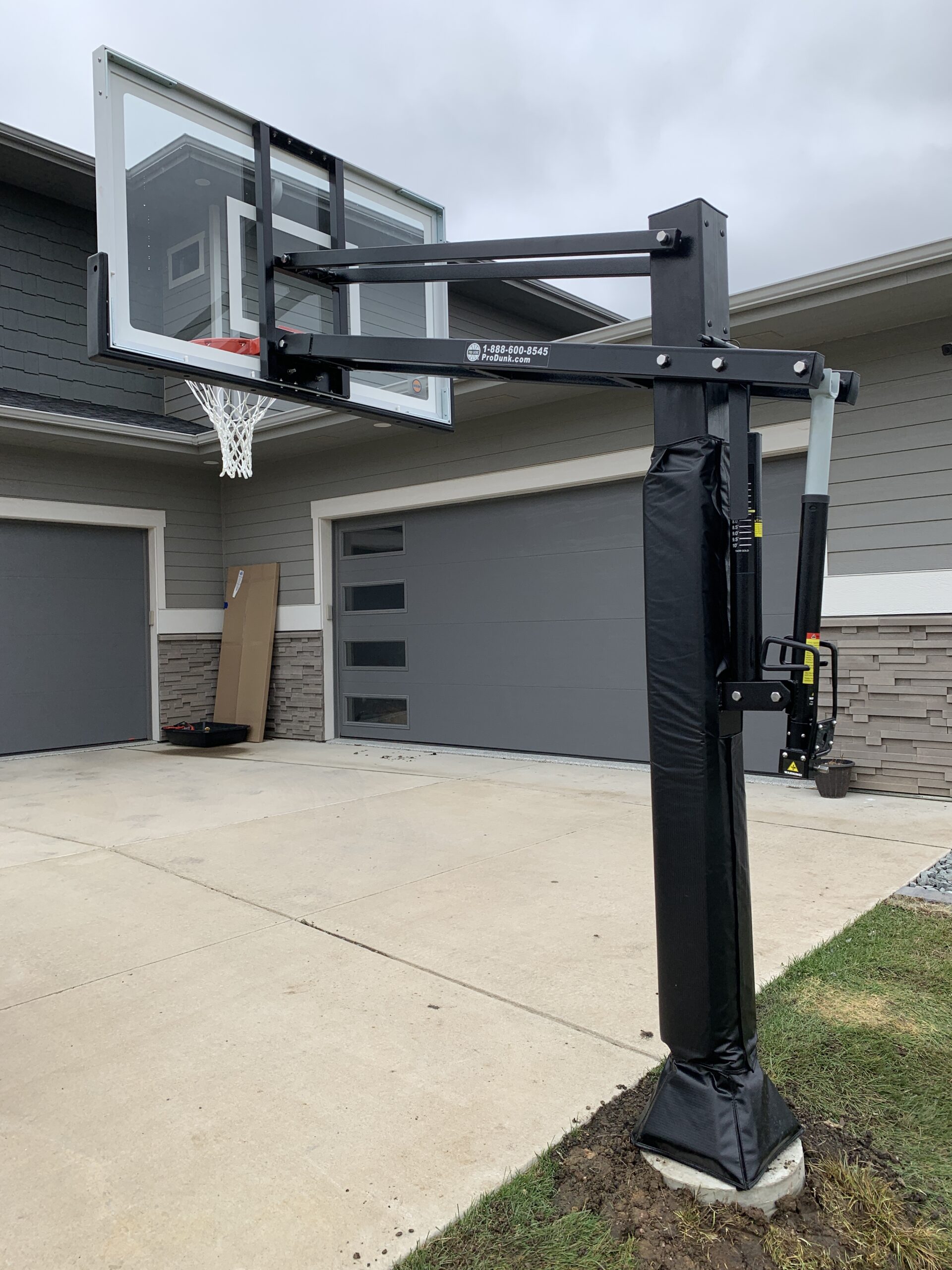 Professional in-ground basketball hoop installation with a concrete base and adjustable backboard in Sioux Falls, SD.