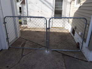 Commercial-grade chain link gate installation with galvanized steel framing and secure latch hardware in Sioux Falls, SD.