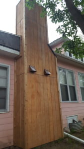 Professional chimney box repair and cedar siding replacement featuring weather-resistant materials in Sioux Falls, SD.