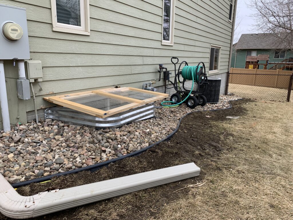Custom heavy-duty egress window cover and safety grate installation for a residential backyard in Harrisburg, SD.