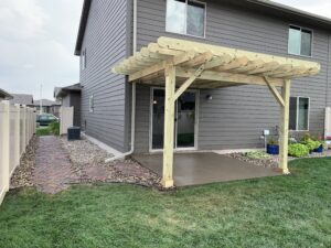 Professional residential exterior remodeling and home improvement services featuring paver steps and a pergola in Sioux Falls, SD.