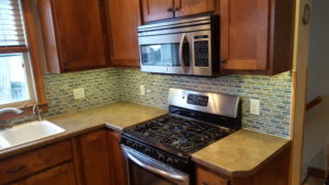 Custom kitchen tile backsplash installation featuring modern patterns for a residential remodel in Sioux Falls, SD.
