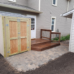 Professional concrete paver patio installation and custom outdoor living space for a new construction home in Harrisburg, SD.