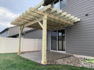 Custom wood pergola installation and decorative outdoor timber structure for a residential patio in Hartford, SD.