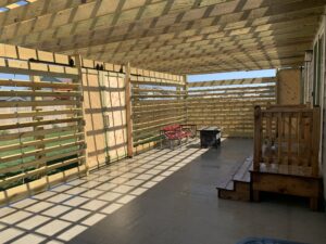 Custom wood pergola installation and decorative outdoor timber structure for a residential patio in Tea, SD.