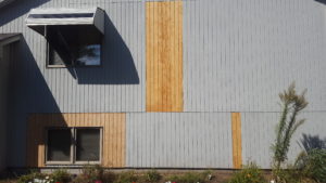 Professional wood siding repair, storm damage restoration, and exterior panel replacement by a local handyman in Sioux Falls, SD.